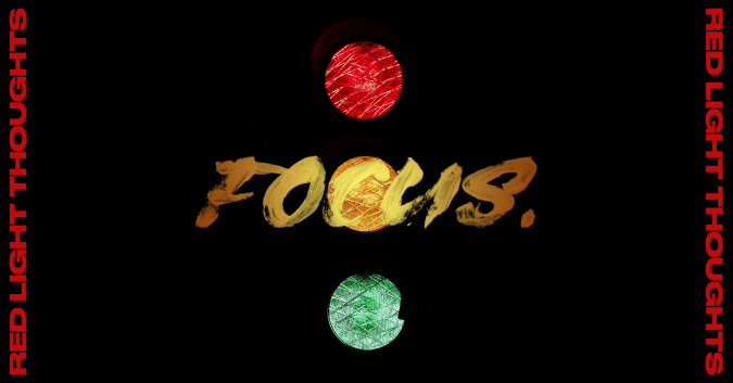 black image with a traffic light behind text that says "Red Light Thoughts: Focus."
